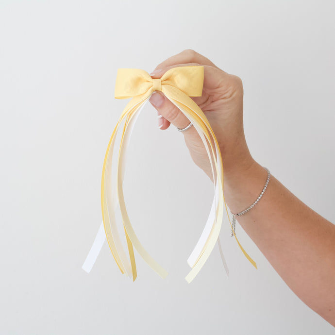 Large yellow tail pinch ribbon bows