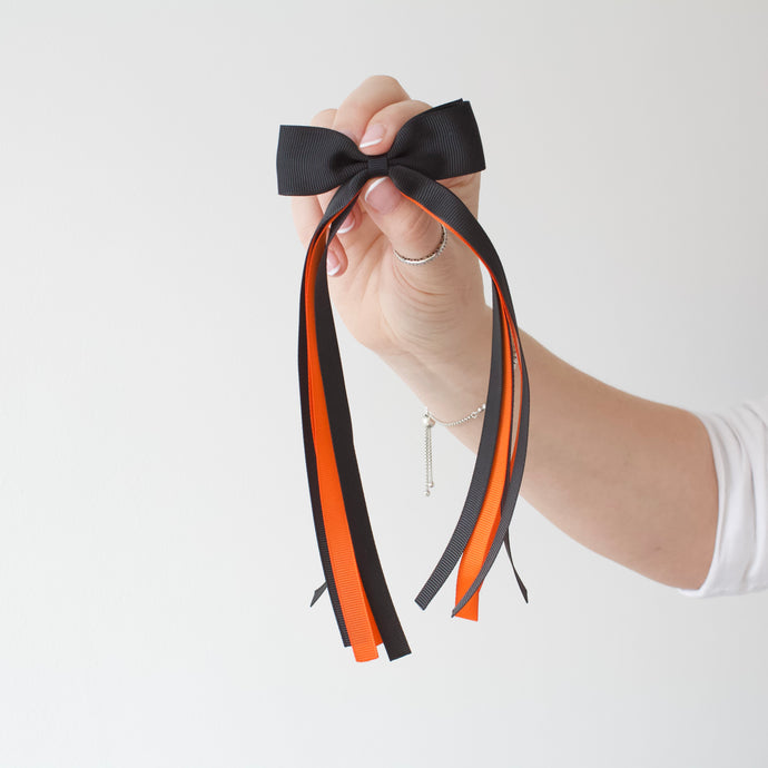 Large orange and black tail pinch ribbon bows