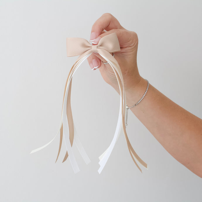 Large beige tail pinch ribbon bows