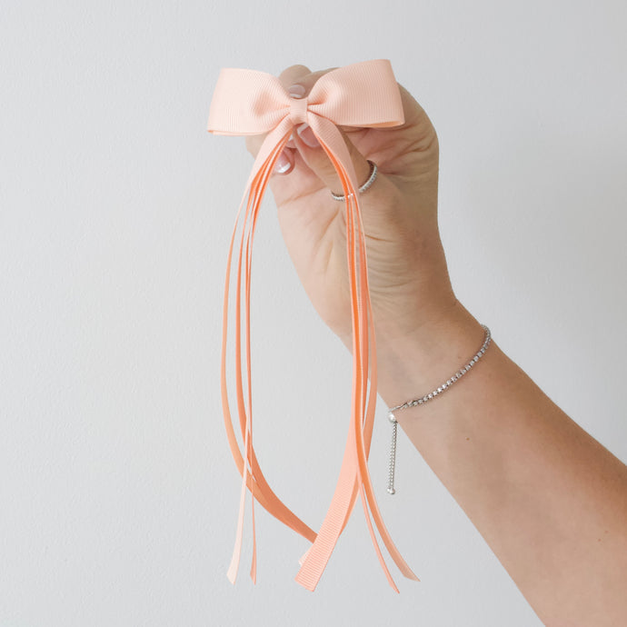 Large peach tail pinch ribbon bows