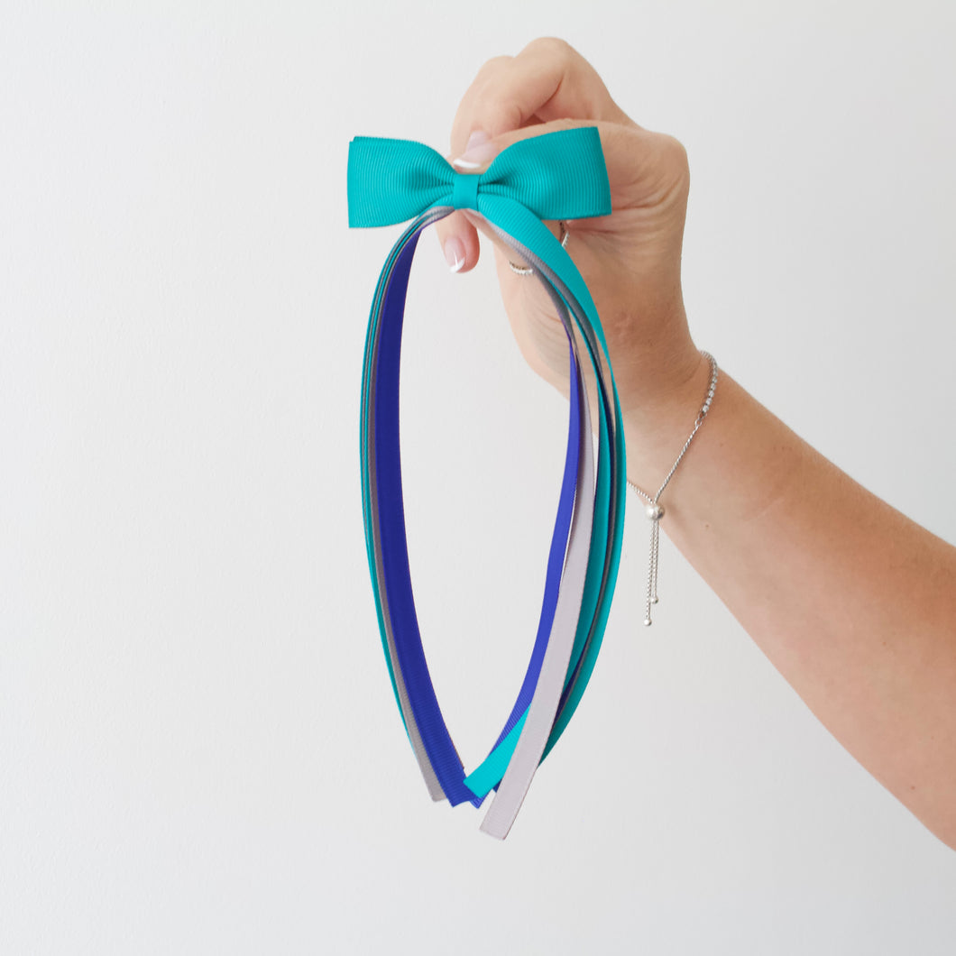 Large teal tail pinch ribbon bows